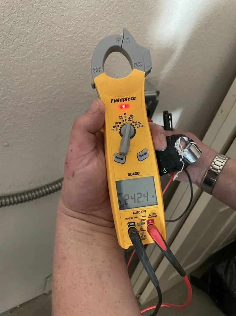 Voltage testing with clamp meter during Electrical Installation Services in Comstock